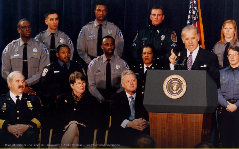Sen. Joe Biden (D-Delaware) speaks at the signing of the 1994 Biden Crime Bill as Attorney General Janet Reno, President Bill Clinton, and local law enforcement officials look on. — related to Biden-Ukraine Quid Pro Quo Conspiracy