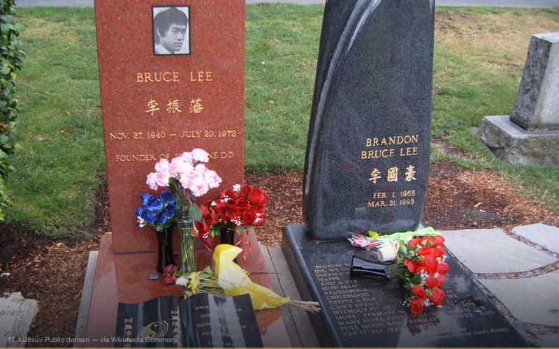 Bruce Lee's headstone along with his son's, Brandon Lee, who died from a bullet firing accidentally during the filming of the movie The Crow. — related to Brandon Lee: The Crow Set Conspiracy
