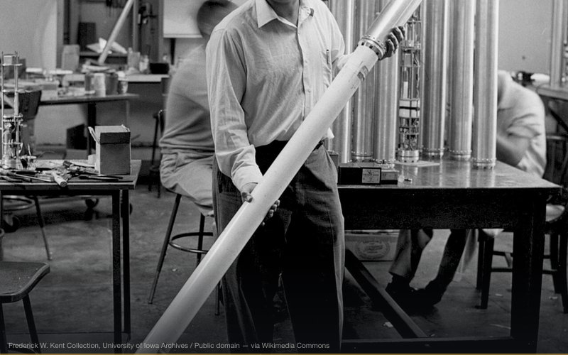 James Van Allen of the University of Iowa poses in workshop with a rocket and scientific instrument package (Rockoon). — related to Van Allen Belt Radiation & Moon Travel
